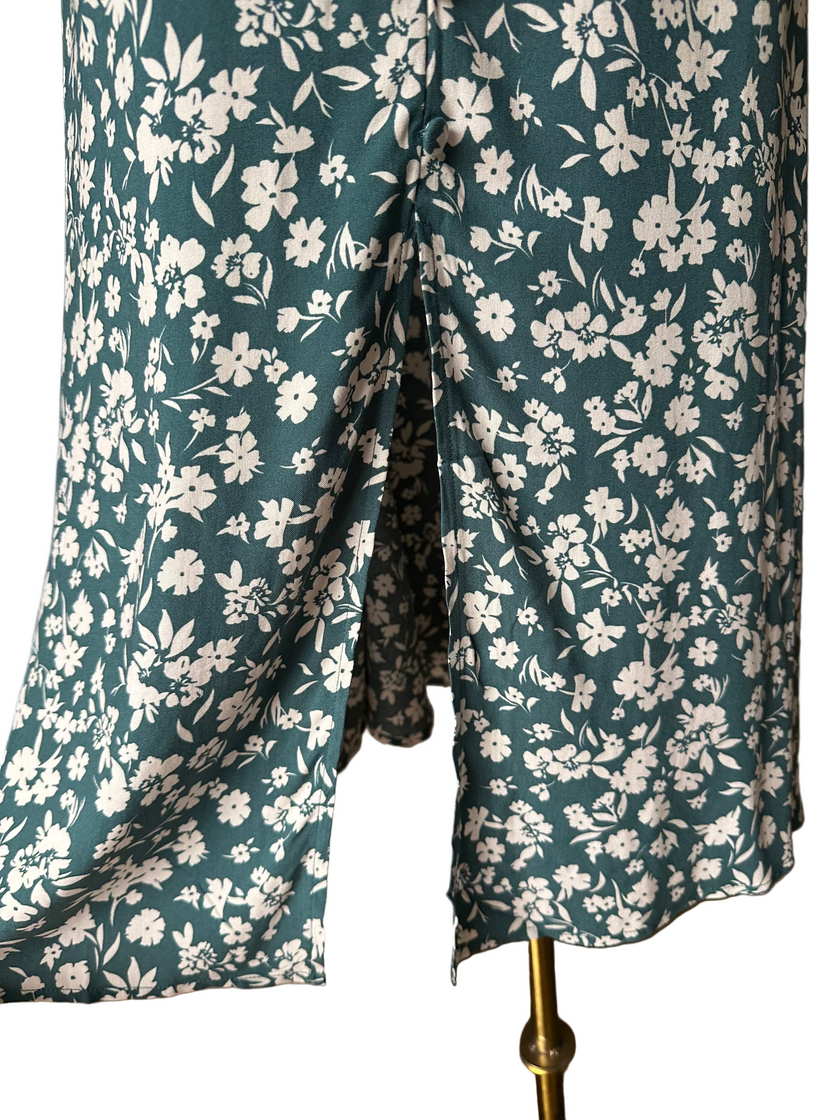 Teal green midi dress with delicate white floral print and v-neckline — soft feminine flow from Justyna Grace Boutique.