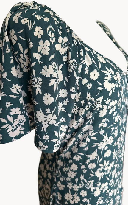 Teal green midi dress with delicate white floral print and v-neckline — soft feminine flow from Justyna Grace Boutique.