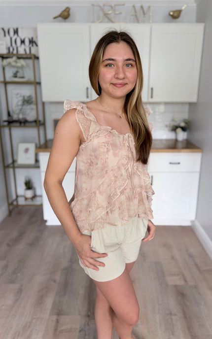 Side view of Floral ruffle v neck top with front tie detail