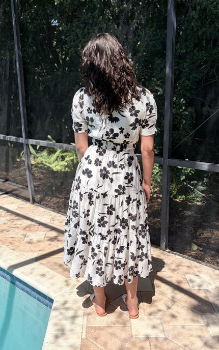 Back view of floral tiered midi dress with soft drape