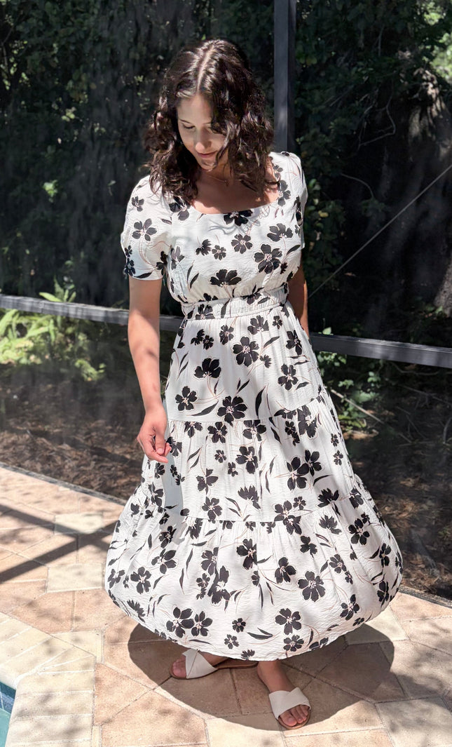Full outfit view of feminine floral midi dress styled for everyday wear