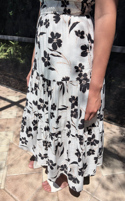Tiered skirt detail on floral midi dress with flowy silhouette