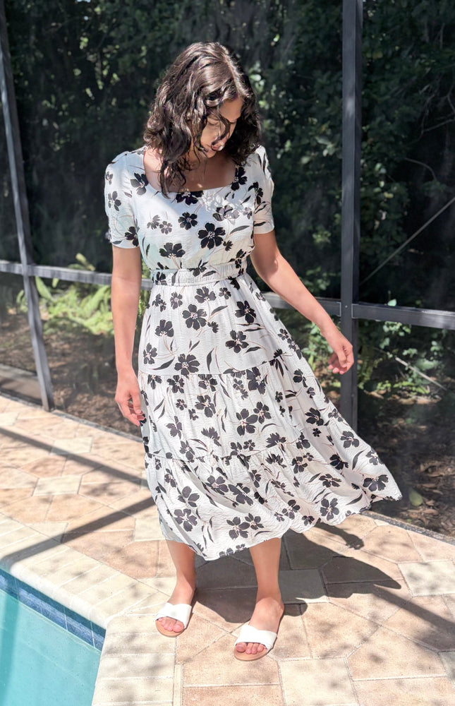 Tiered skirt detail on floral midi dress with flowy silhouette