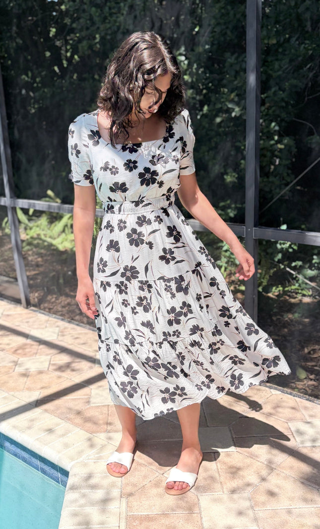 Tiered skirt detail on floral midi dress with flowy silhouette