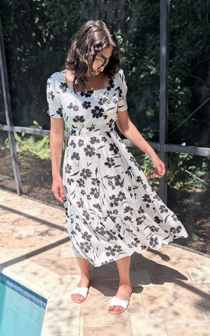 Tiered skirt detail on floral midi dress with flowy silhouette