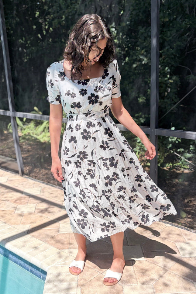 Tiered skirt detail on floral midi dress with flowy silhouette