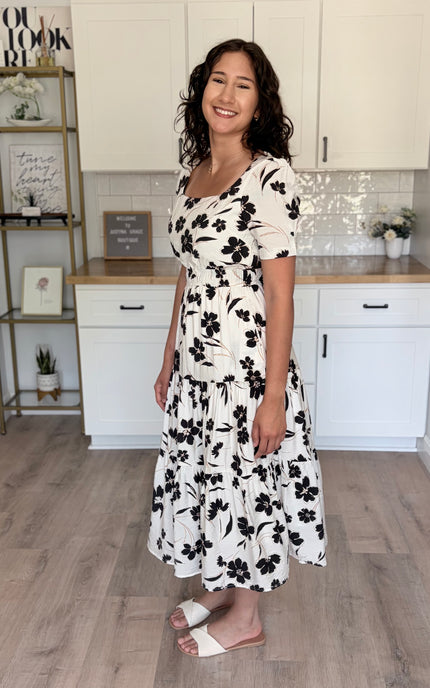 Side view of feminine floral midi dress styled for everyday wear