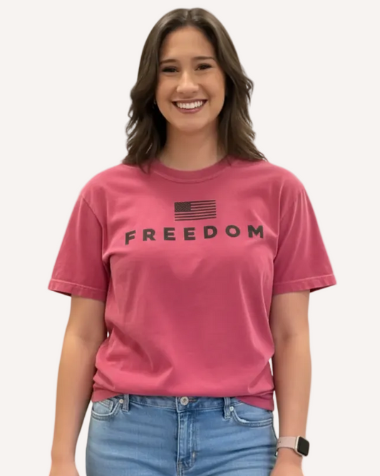 Person wearing a pink 'FREEDOM' t-shirt 