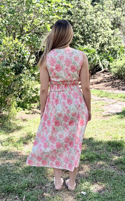 Back view of Garden Floral Cotton Midi Dress showing sleeveless bodice, smocked waist, center-back zipper detail, and graceful midi silhouette on woman wearing size Small