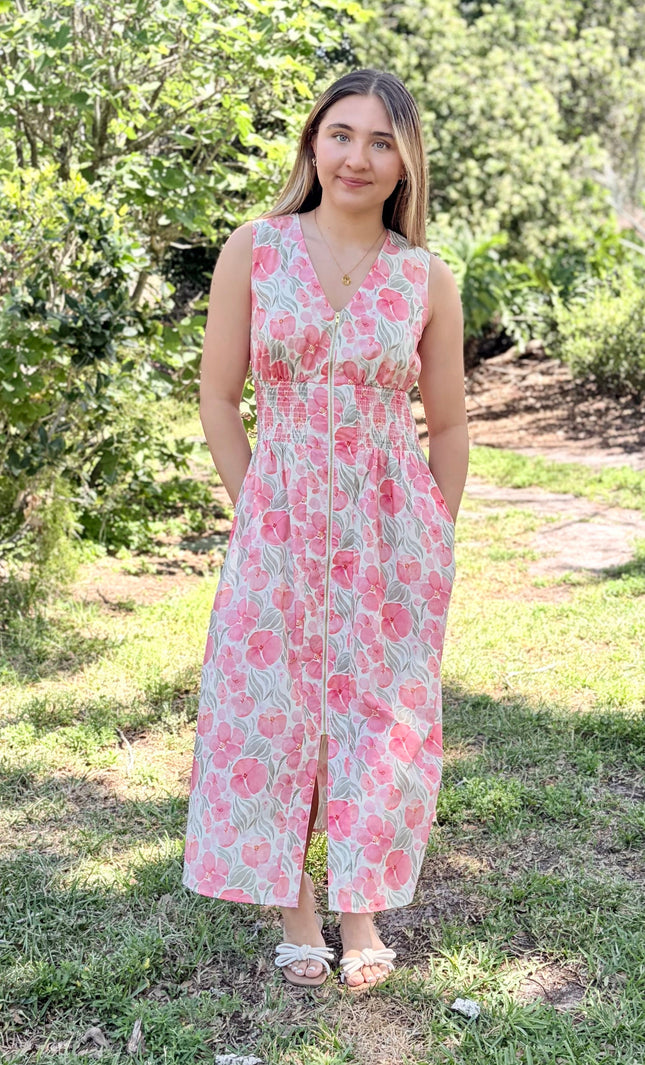Woman wearing Garden Floral Cotton Midi Dress in watercolor floral print, size Small, front view showing V-neckline, smocked waist, center-front zipper, and modest midi length