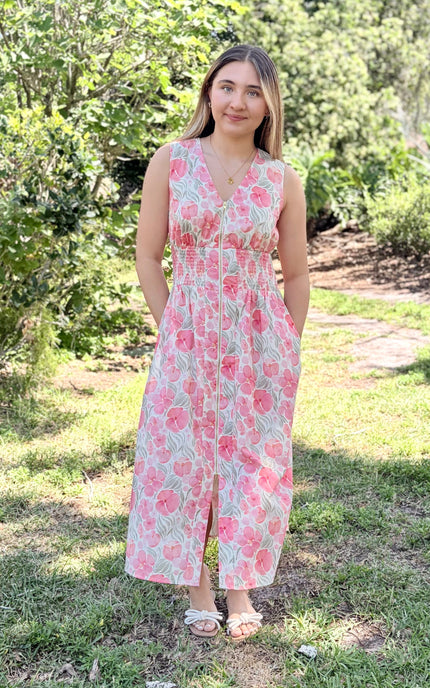 Woman wearing Garden Floral Cotton Midi Dress in watercolor floral print, size Small, front view showing V-neckline, smocked waist, center-front zipper, and modest midi length