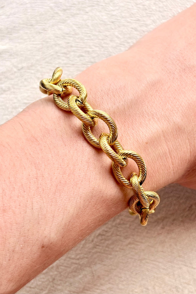 gold cable link bracelet on soft linen background in natural light, chunky everyday jewelry
