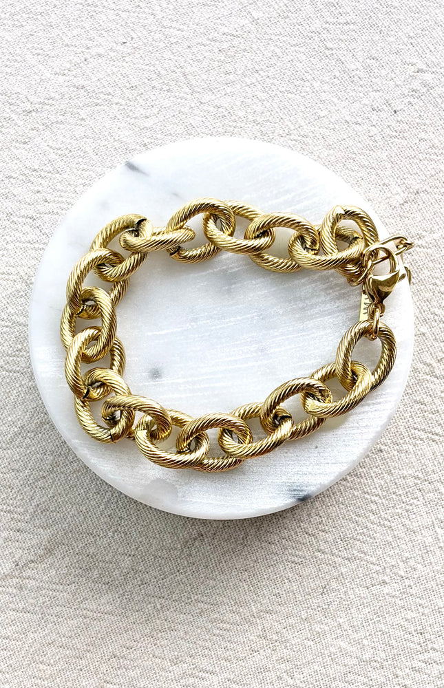 gold cable link bracelet on soft linen background in natural light, chunky everyday jewelry
