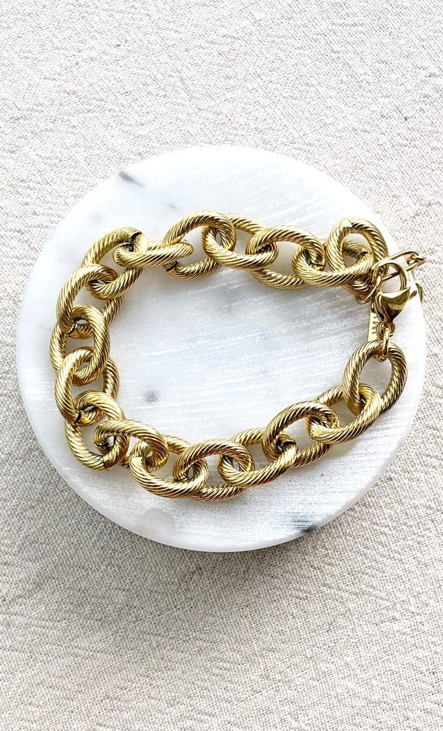 gold cable link bracelet on soft linen background in natural light, chunky everyday jewelry
