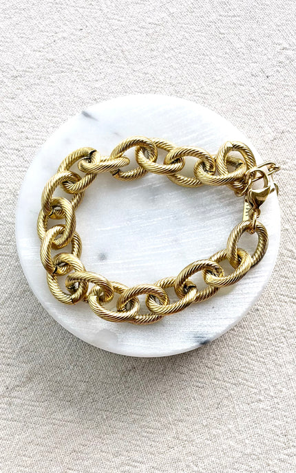 gold cable link bracelet on soft linen background in natural light, chunky everyday jewelry
