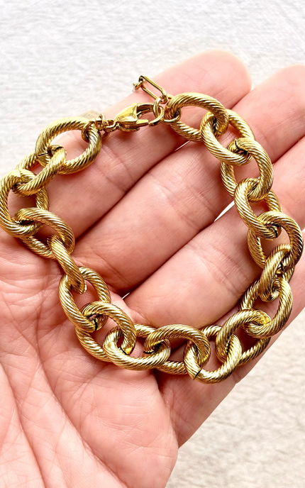 gold chain link bracelet minimal flat lay, bold statement jewelry
