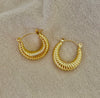 Golden Croissant Hoops — 18K gold-plated stainless steel earrings with ribbed texture and polished finish from Justyna Grace Boutique.