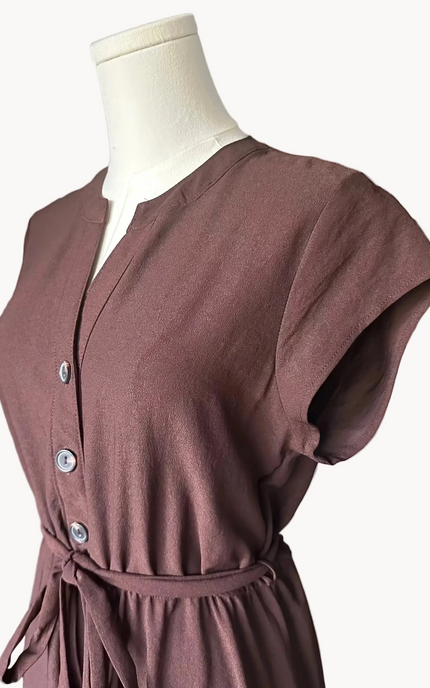 Brown dress on a mannequin against a light pink background