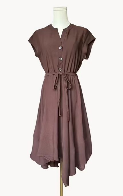 Brown dress on a mannequin against a light pink background