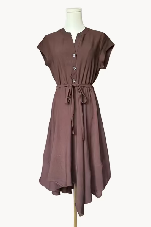 Brown dress on a mannequin against a light pink background