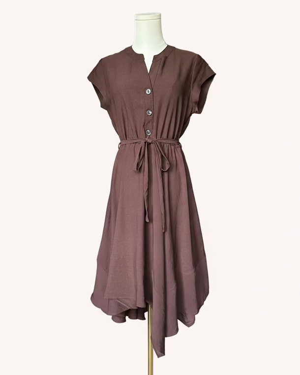 Brown dress on a mannequin against a light pink background