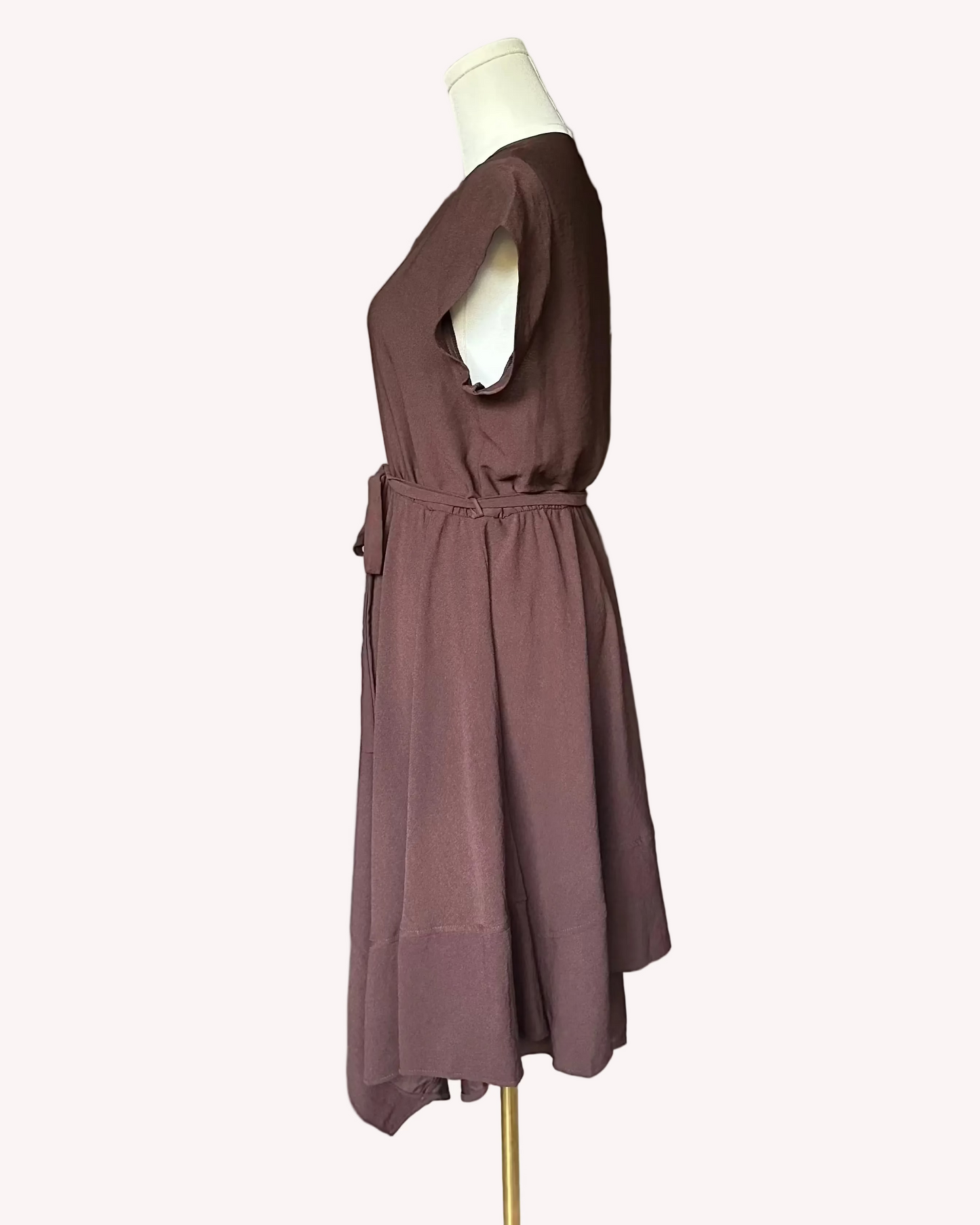 Brown dress on a mannequin against a white background