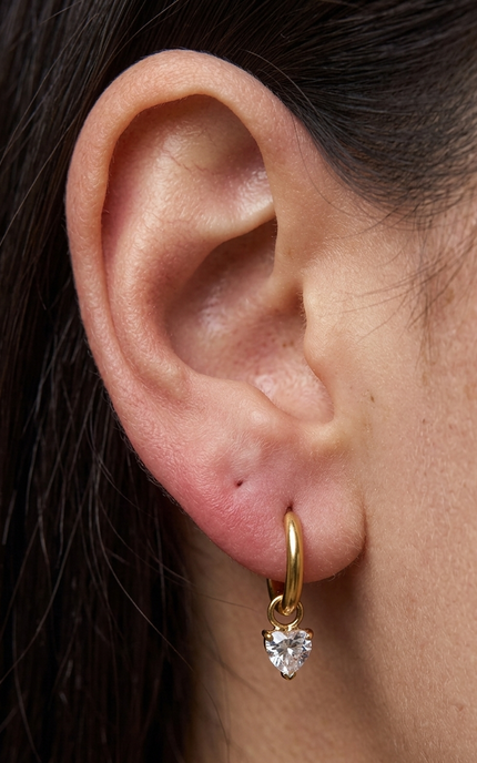 Heart crystal drop hoop earrings worn on ear showing feminine silhouette and delicate sparkle detail