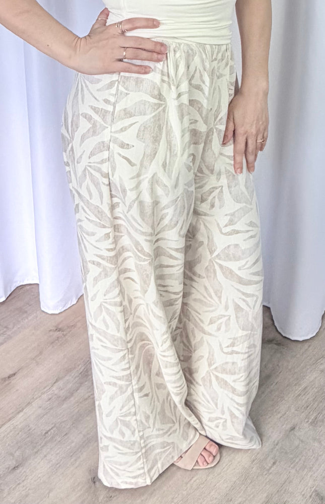 Close-up side profile of women's leaf print pants featuring a breathable rayon linen blend and clean silhouette.