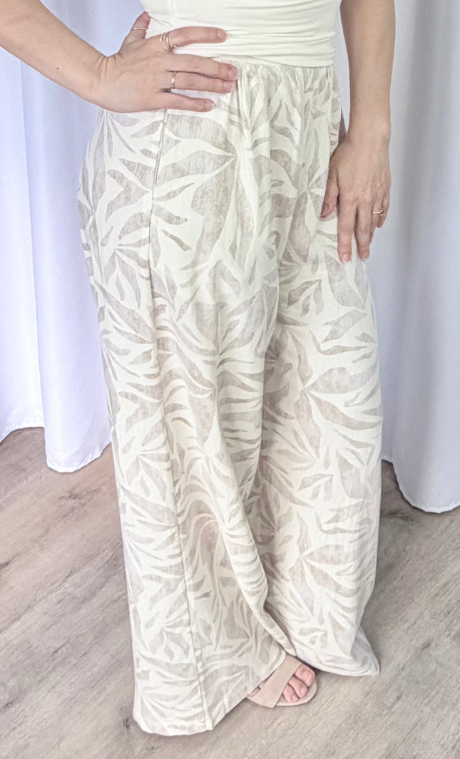 Close-up side profile of women's leaf print pants featuring a breathable rayon linen blend and clean silhouette.