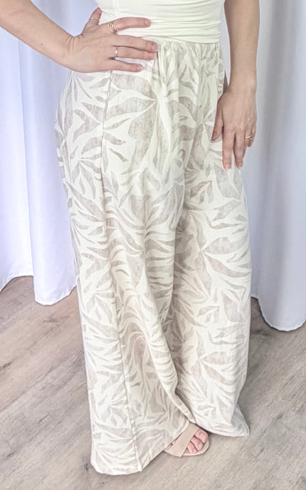 Close-up side profile of women's leaf print pants featuring a breathable rayon linen blend and clean silhouette.