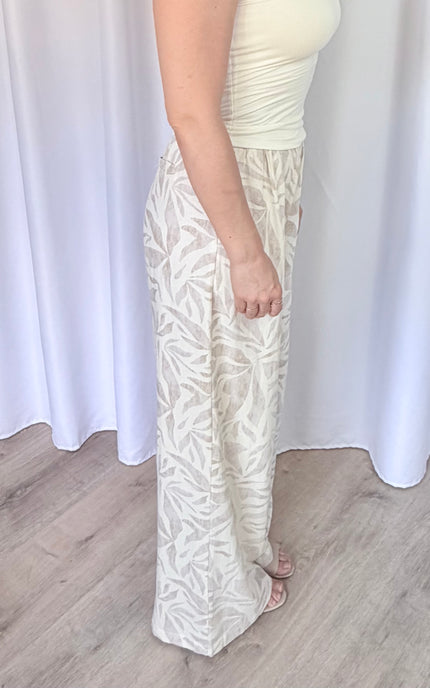 Side detail of island leaf print pants showing the relaxed fit, lightweight construction, and tropical pattern.