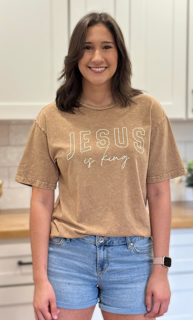 Gold mineral-wash “Jesus Is King” graphic tee with relaxed unisex fit and vintage garment-dyed finish.