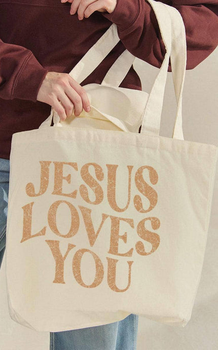 Jesus Loves You canvas tote bag front view with bold faith graphic