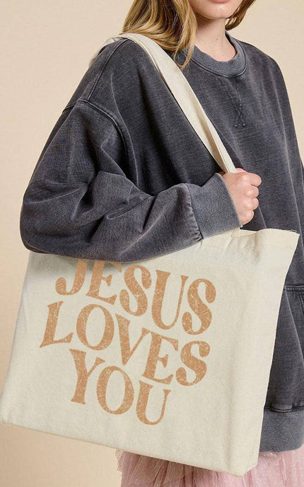 Jesus Loves You canvas tote bag front view with bold faith graphic