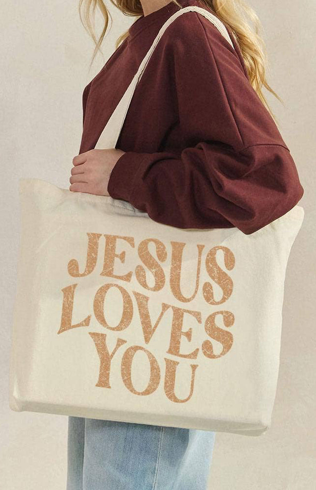 Jesus Loves You canvas tote bag front view with bold faith graphic