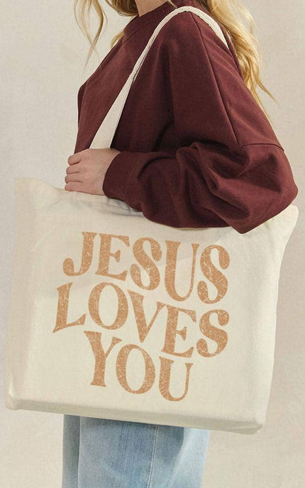 Jesus Loves You canvas tote bag front view with bold faith graphic