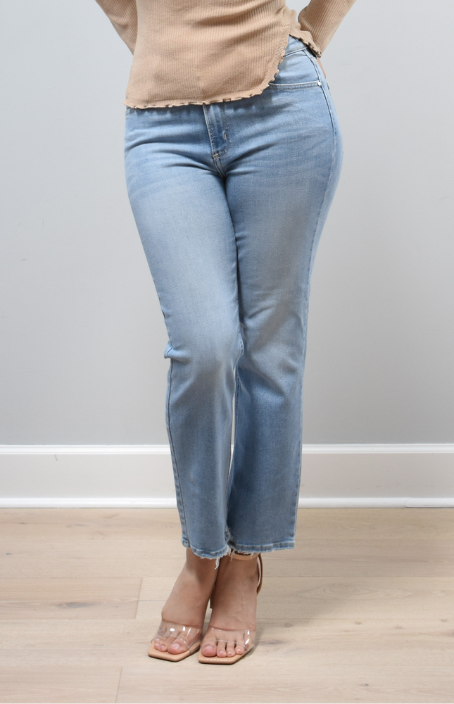 Light-wash straight-leg jeans with mid-high rise shown from the front on model, styled with neutral top.