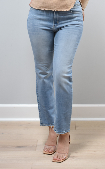 Light-wash straight-leg jeans with mid-high rise shown from the front on model, styled with neutral top.