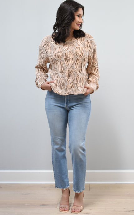 Light-wash straight-leg jeans with mid-high rise shown from the front on model, styled with neutral top.