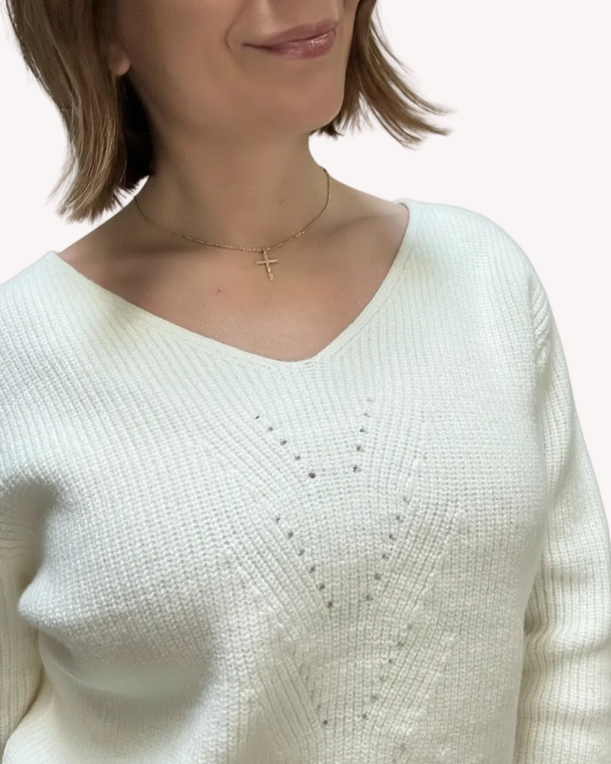 Off-white ribbed sweater with lace-trim V-neckline and oversized bow detail draping down the back, photographed on a Soft Linen background for Justyna Grace Boutique.