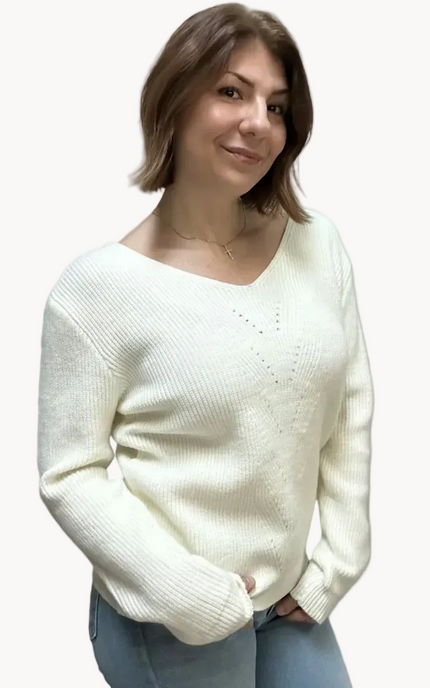 Off-white ribbed sweater with lace-trim V-neckline and oversized bow detail draping down the back, photographed on a Soft Linen background for Justyna Grace Boutique.