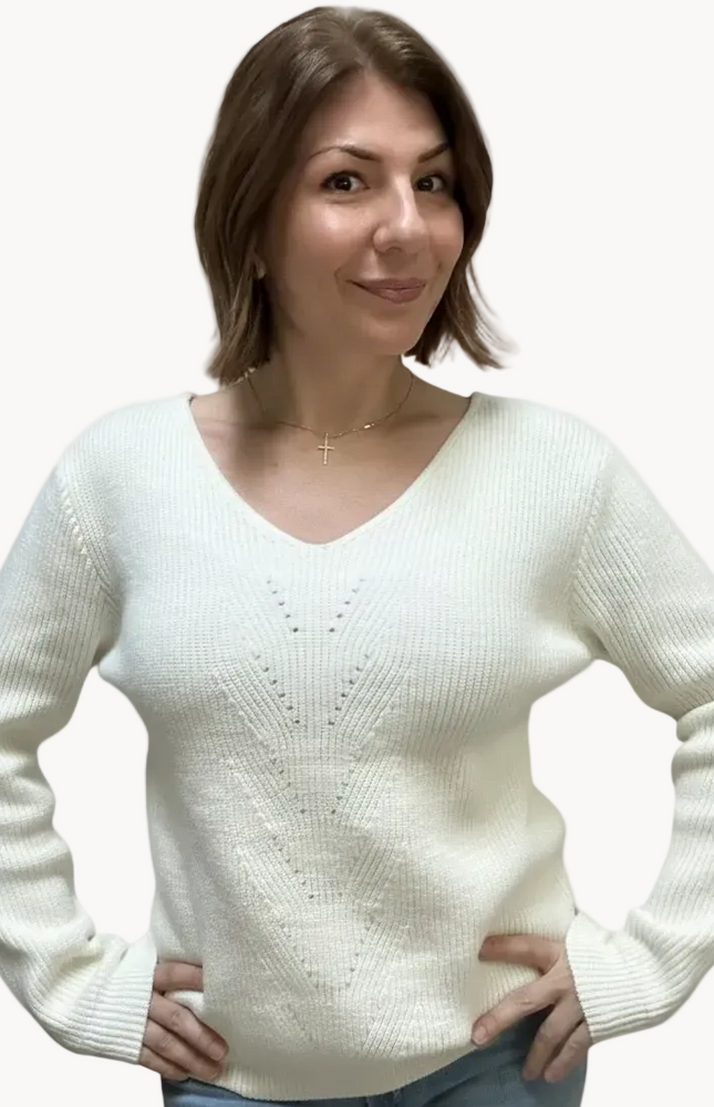 Off-white ribbed sweater with lace-trim V-neckline and oversized bow detail draping down the back, photographed on a Soft Linen background for Justyna Grace Boutique.