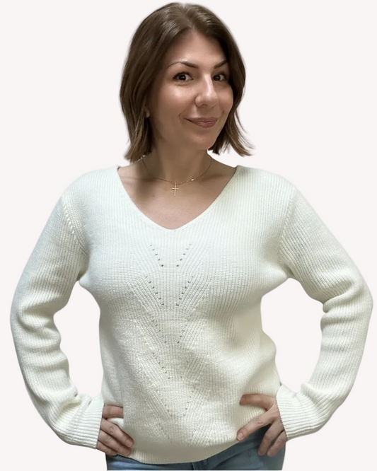 Off-white ribbed sweater with lace-trim V-neckline and oversized bow detail draping down the back, photographed on a Soft Linen background for Justyna Grace Boutique.