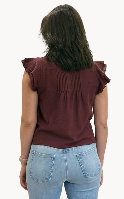 Lightweight 100% cotton top with V-neck button detail, pintuck accents, and ruffle trim – relaxed flowy silhouette in airy woven fabric – front view on soft linen background – Justyna Grace Boutique