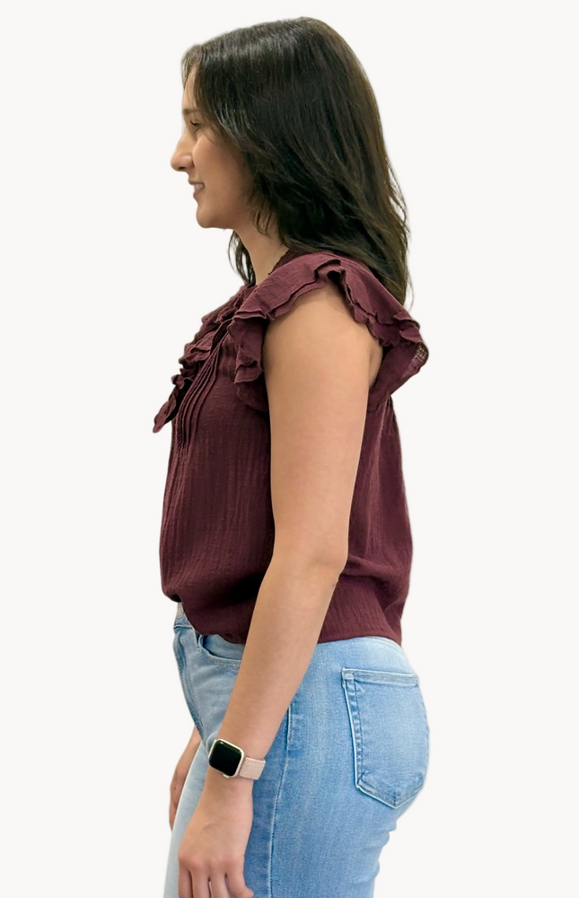 Lightweight 100% cotton top with V-neck button detail, pintuck accents, and ruffle trim – relaxed flowy silhouette in airy woven fabric – front view on soft linen background – Justyna Grace Boutique