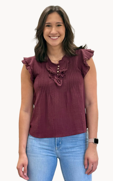 Lightweight 100% cotton top with V-neck button detail, pintuck accents, and ruffle trim – relaxed flowy silhouette in airy woven fabric – front view on soft linen background – Justyna Grace Boutique
