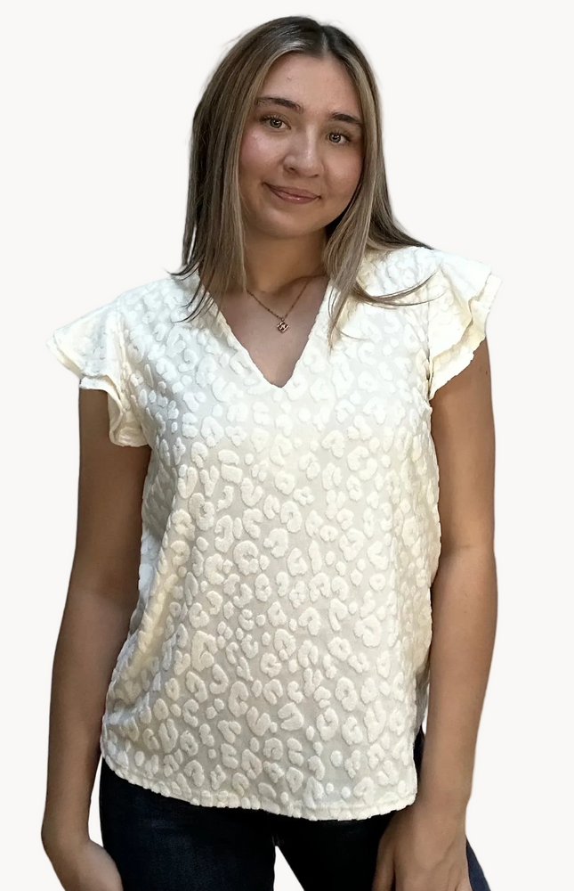 Louisiana Top with subtle tonal animal-print texture, soft ruffle sleeves, and V-neckline – lightweight relaxed silhouette – front view on soft linen background – Justyna Grace Boutique