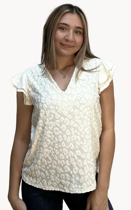 Louisiana Top with subtle tonal animal-print texture, soft ruffle sleeves, and V-neckline – lightweight relaxed silhouette – front view on soft linen background – Justyna Grace Boutique