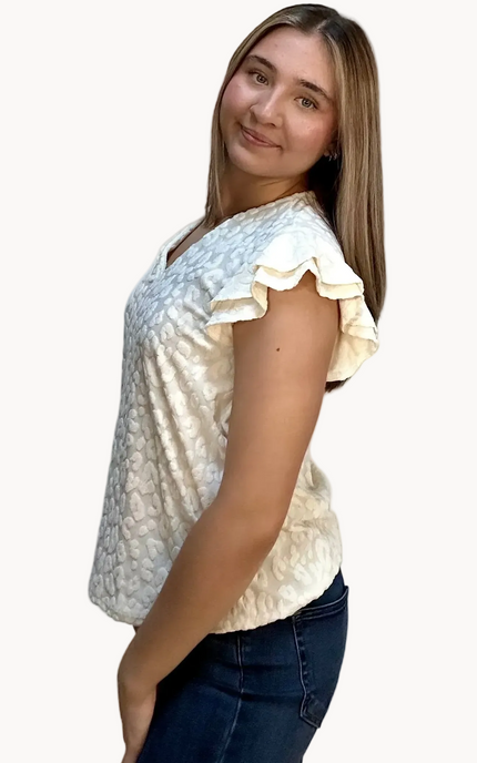 Louisiana Top with subtle tonal animal-print texture, soft ruffle sleeves, and V-neckline – lightweight relaxed silhouette – front view on soft linen background – Justyna Grace Boutique