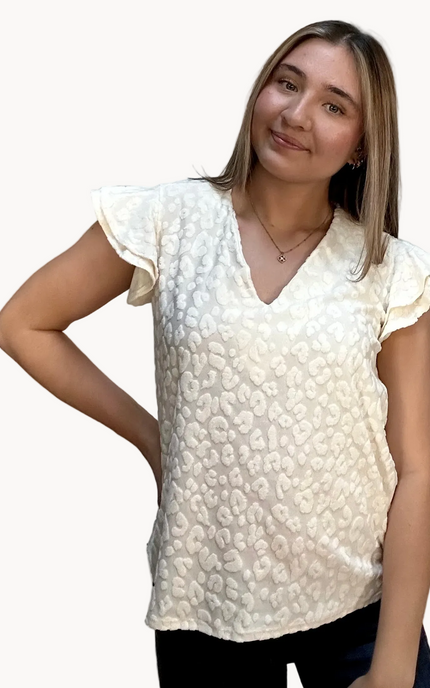 Louisiana Top with subtle tonal animal-print texture, soft ruffle sleeves, and V-neckline – lightweight relaxed silhouette – front view on soft linen background – Justyna Grace Boutique
